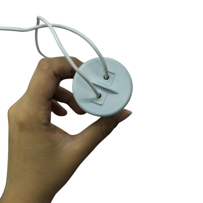 Hand holding a Syscap 55uF motor run capacitor 450V with attached wires for electrical applications
