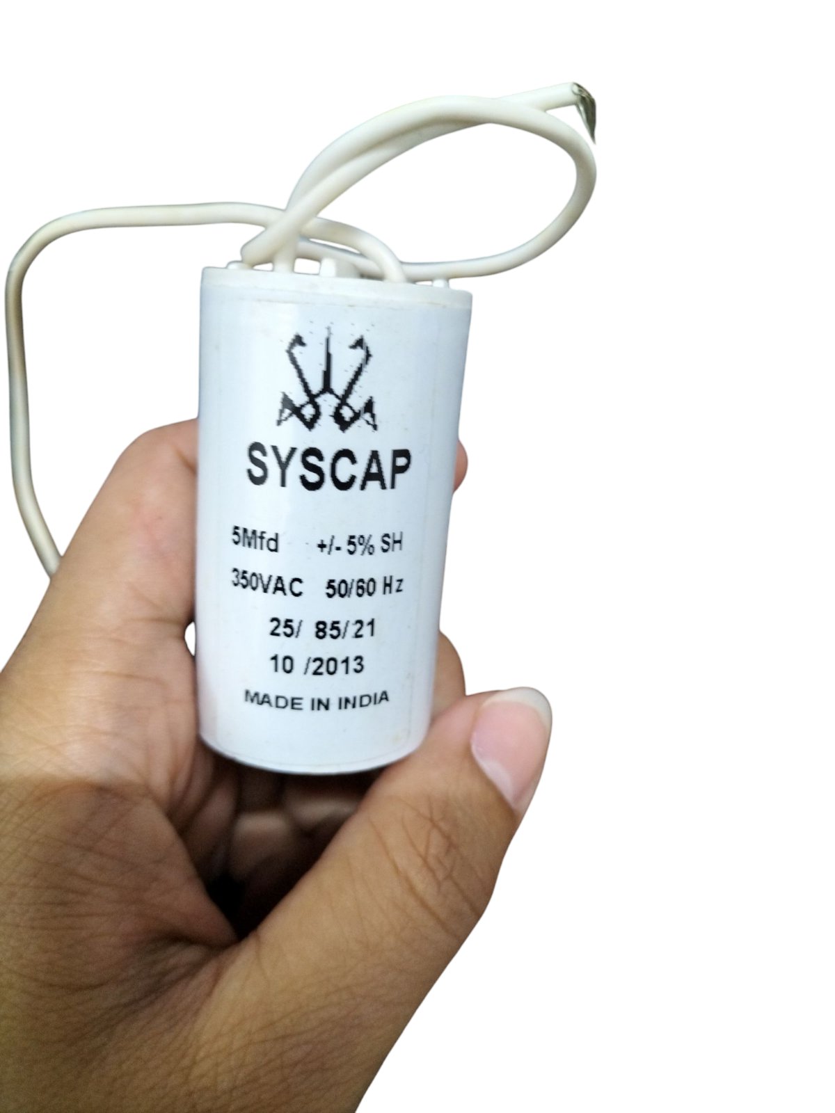 Syscap 5MFD Motor Running Capacitor held in hand with white wiring and product details