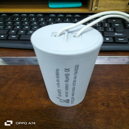 Syscap 60MFD 450V AC motor running capacitor cylindrical white with wires on wooden table