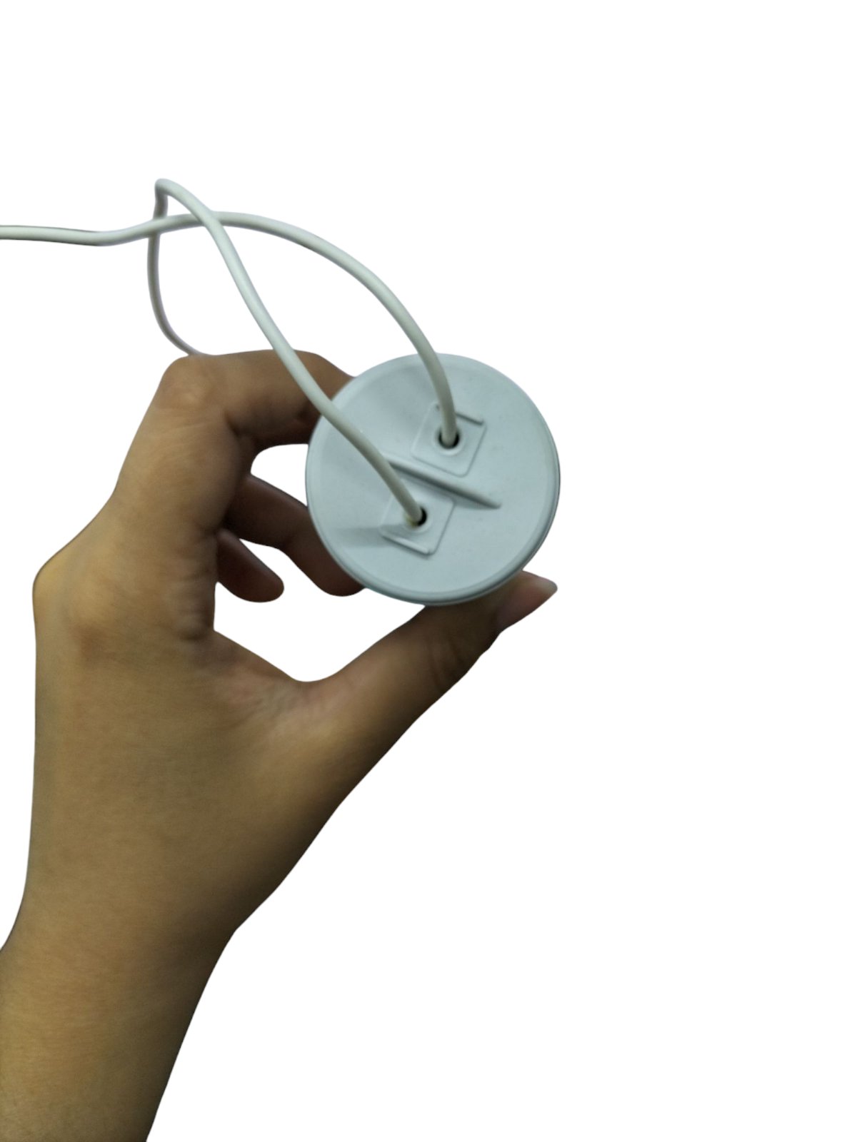 Hand holding SYSCAP 75mfd 250V AC Motor running capacitor with white wires for electrical circuitry