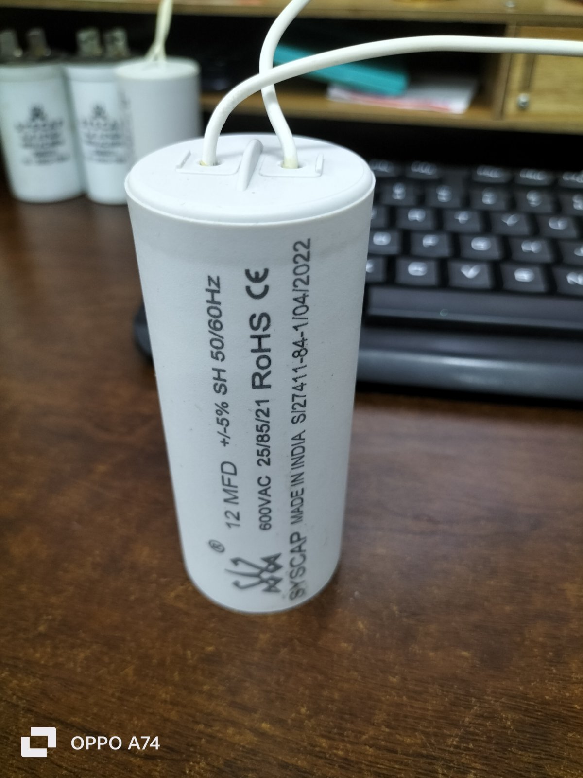 Syscap motor capacitor 12 MFD 600VAC electrical circuitry part with white wires