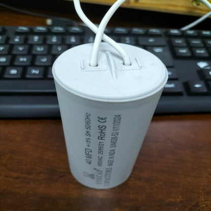 Syscap motor capacitor with white wires standing