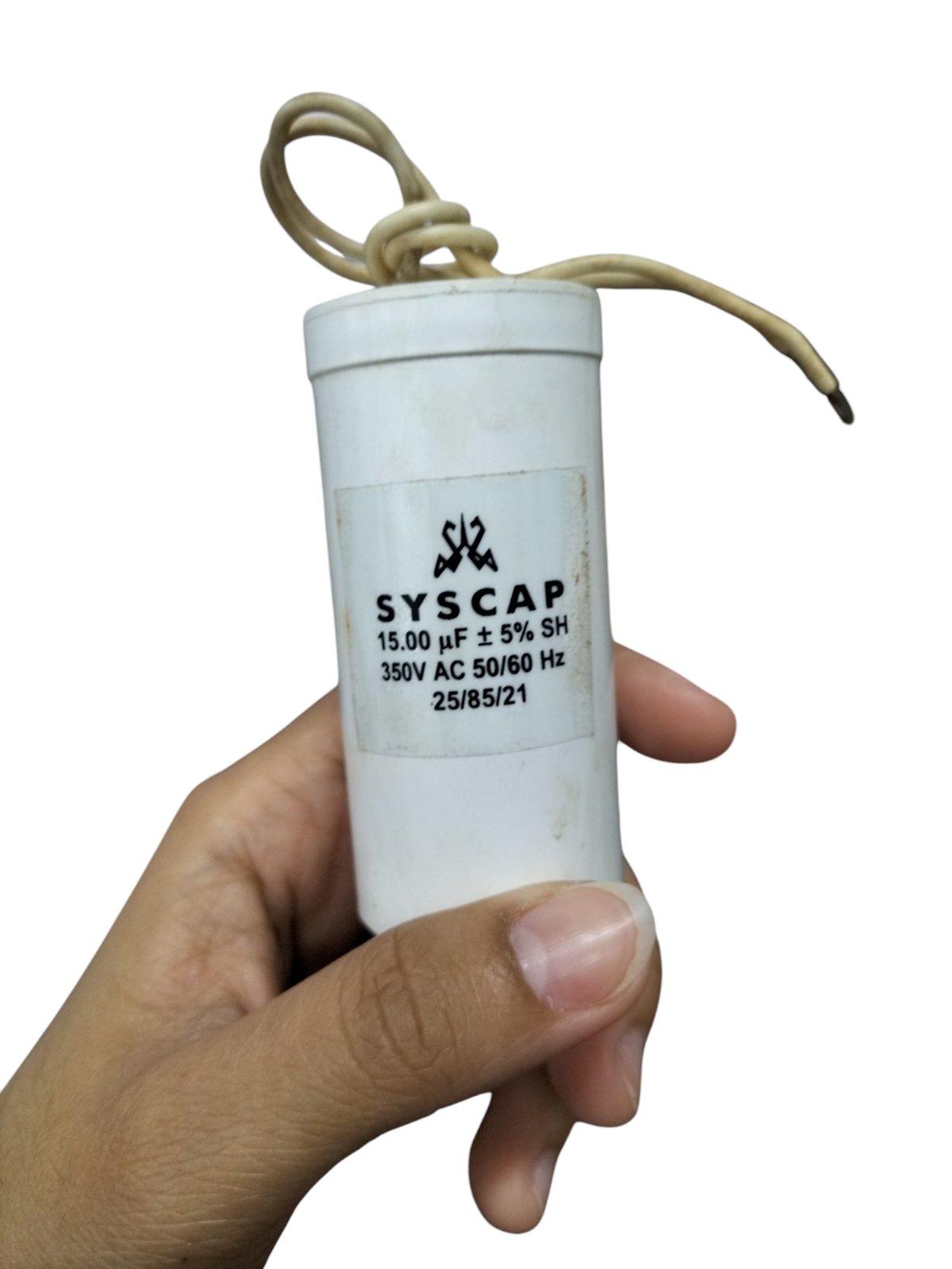 Syscap motor running capacitor 15mfd held in hand for electrical circuitry and parts