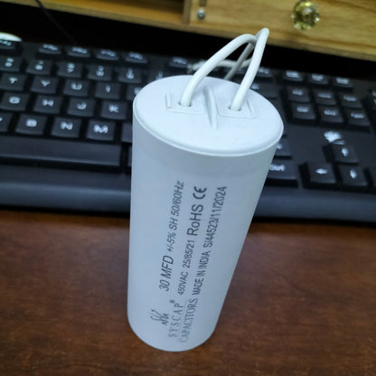 Syscap motor running capacitor 30 MFD electrical component with wires.