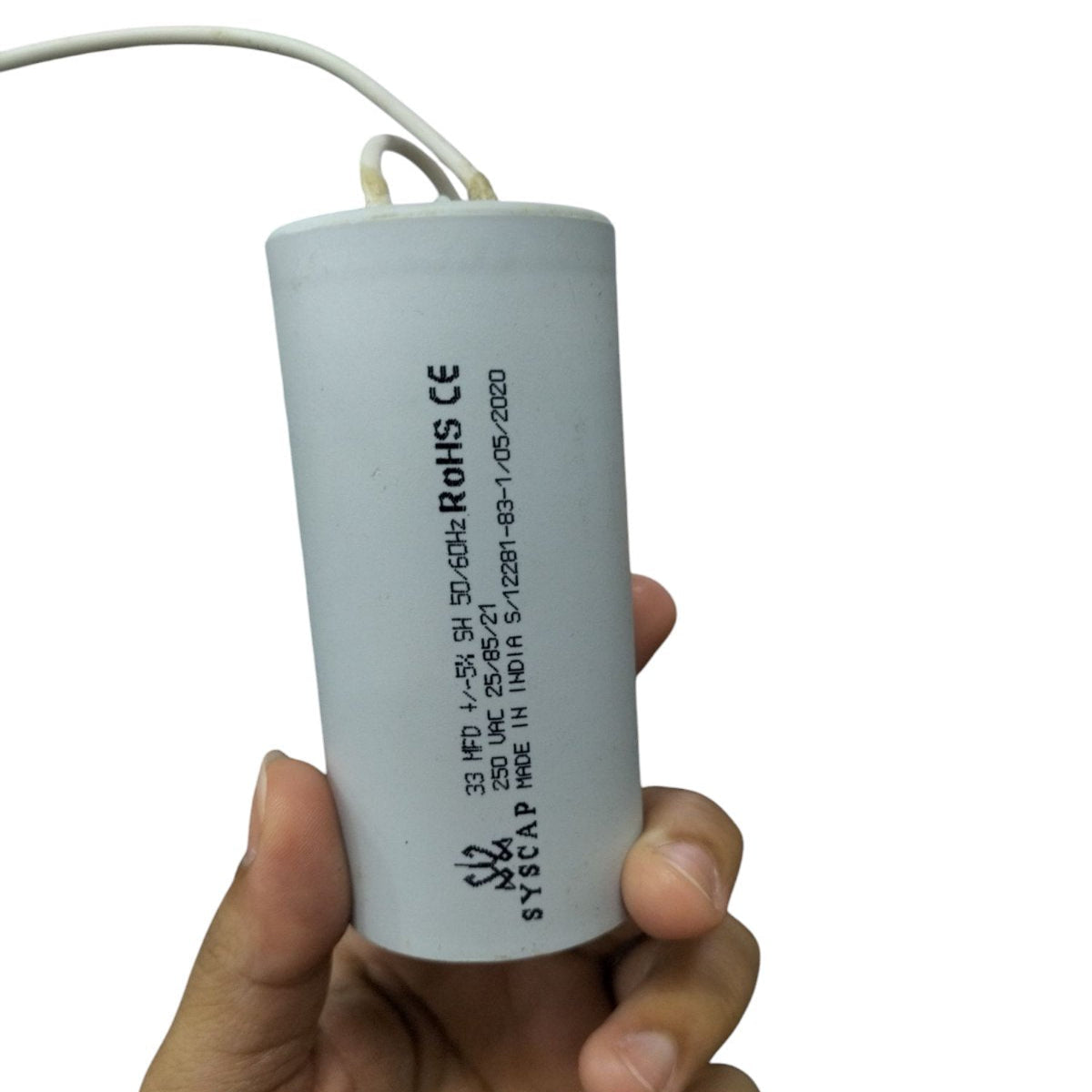 Syscap Motor Running Capacitor 33MFD electrical component held in hand for motor applications