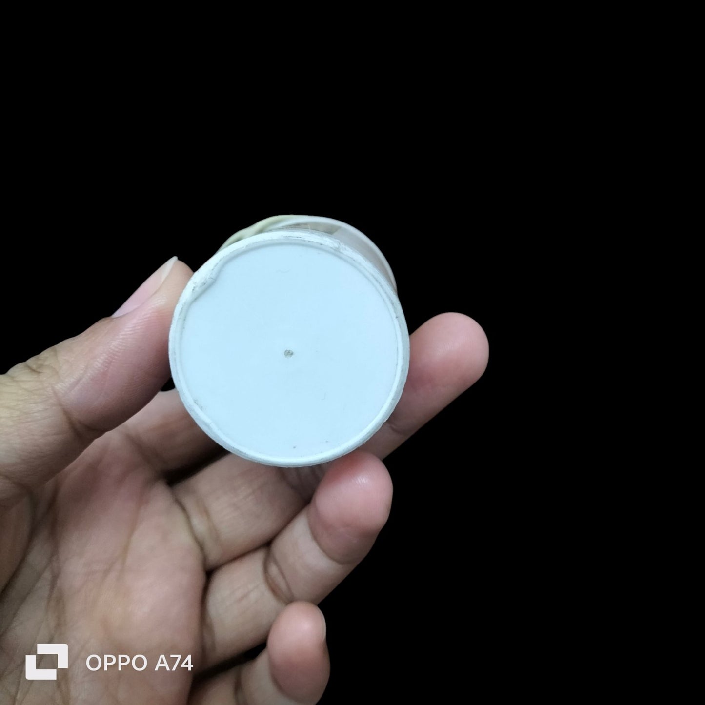 Syscap Run Capacitor 14UF 500 VAC held in hand showing top view of electrical circuitry part