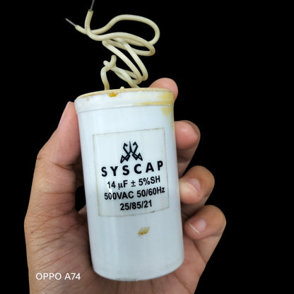 Syscap Run Capacitor 14UF 500 VAC electrical component with wires held in hand for circuitry use
