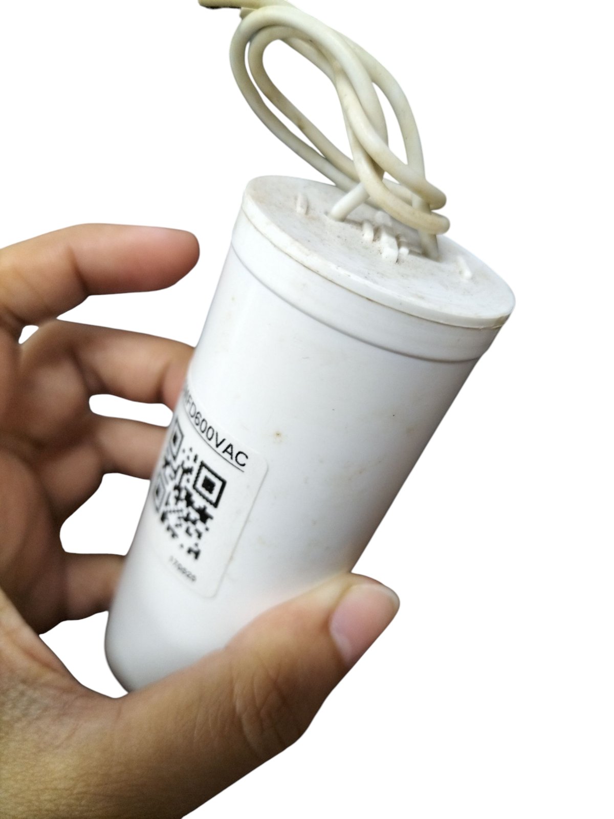 Syscap Running Capacitor 15uF 600V held in hand, ideal for electrical circuit applications