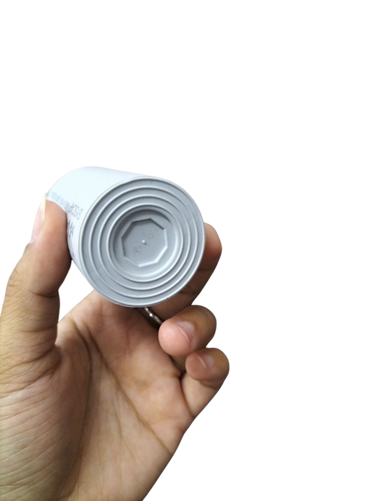 Syscap Running Capacitor 25MFD 250V shown from the top in a hand for electrical applications