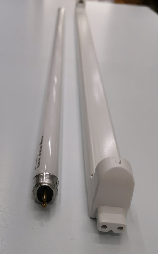 Philips T5 Fluorescent Lamp 28 Watts Daylight tube next to a white fluorescent fixture on a white surface