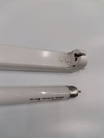 Philips T5 Fluorescent Lamp 28 Watts Daylight tube next to white lamp fixture on a white surface