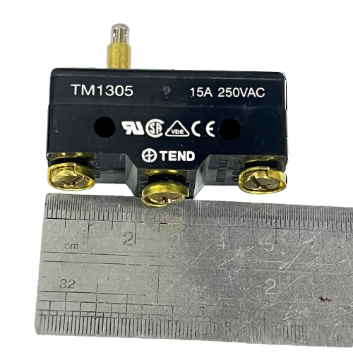 Limit Switch 15A 250VAC TM1305 black Tend control switch with metal plunger actuator and three screw terminals beside ruler