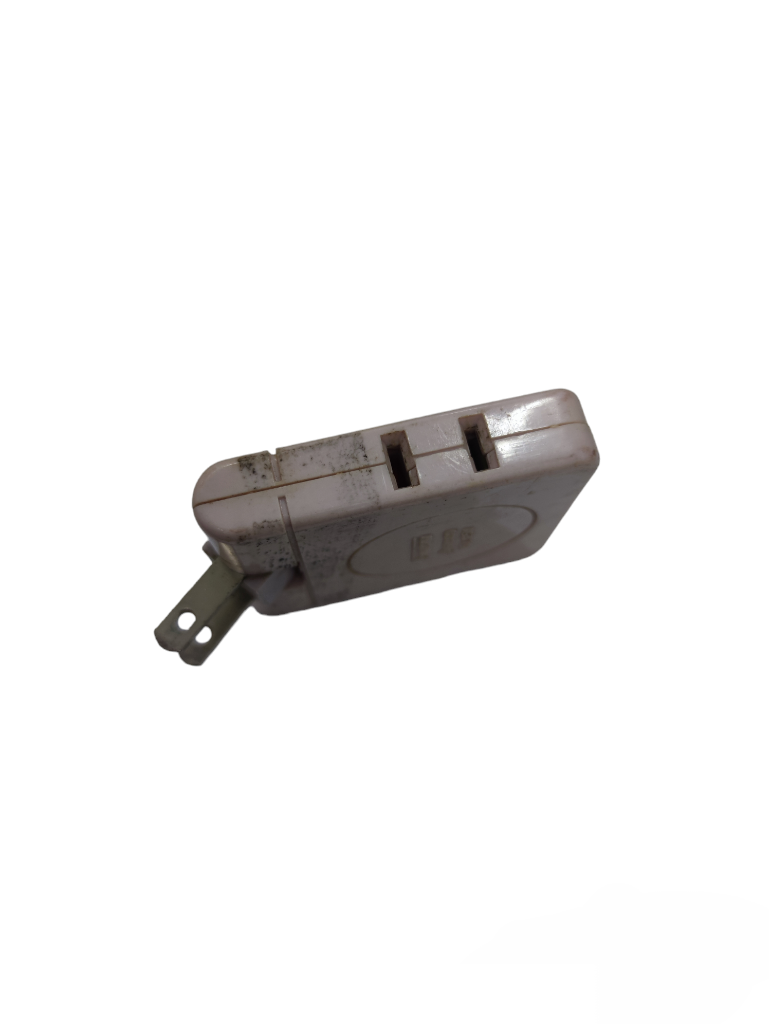 Used Type Cube Tap 15A 125V 1650W power plug with two outlets and worn white casing