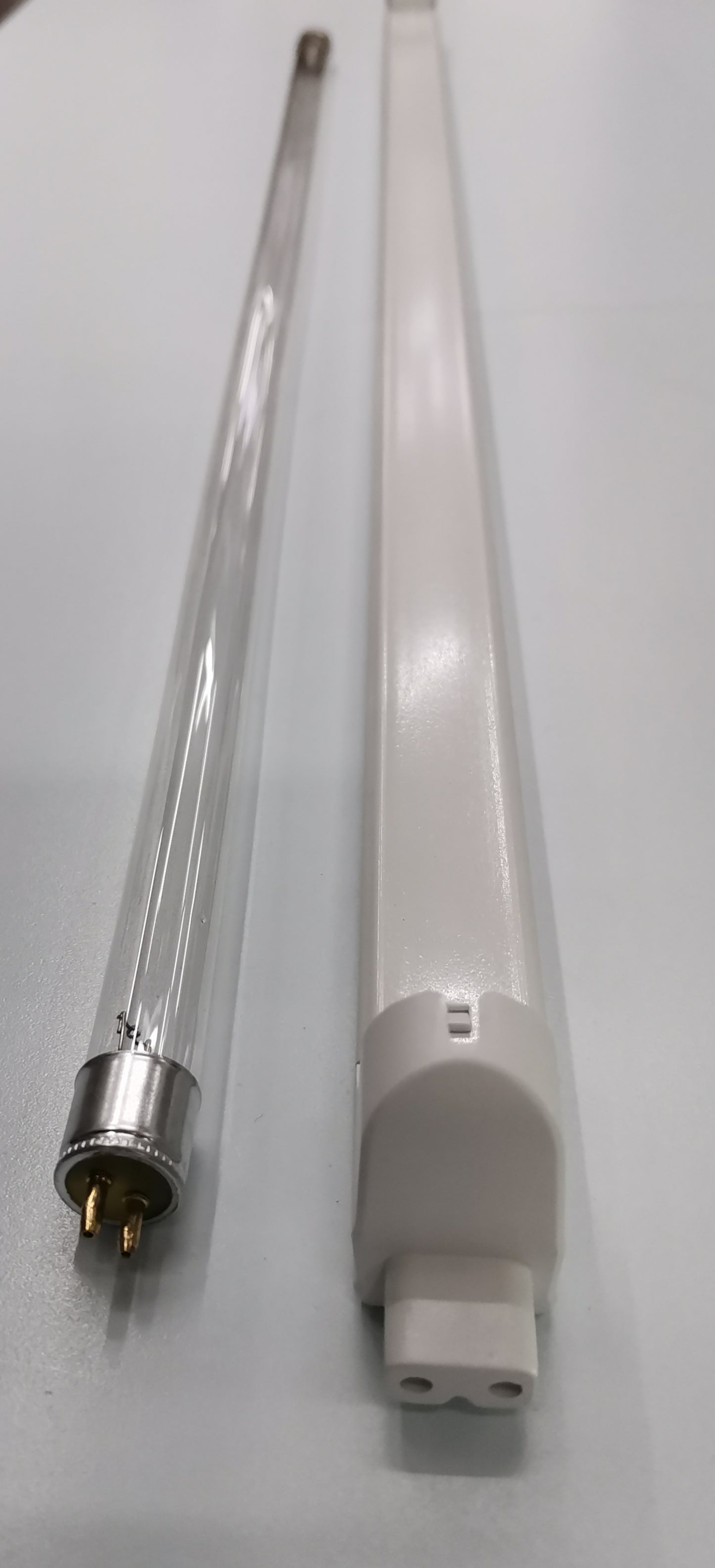 Philips UVC T5 fluorescent lamp 14 watt shown with clear and white casing tubes