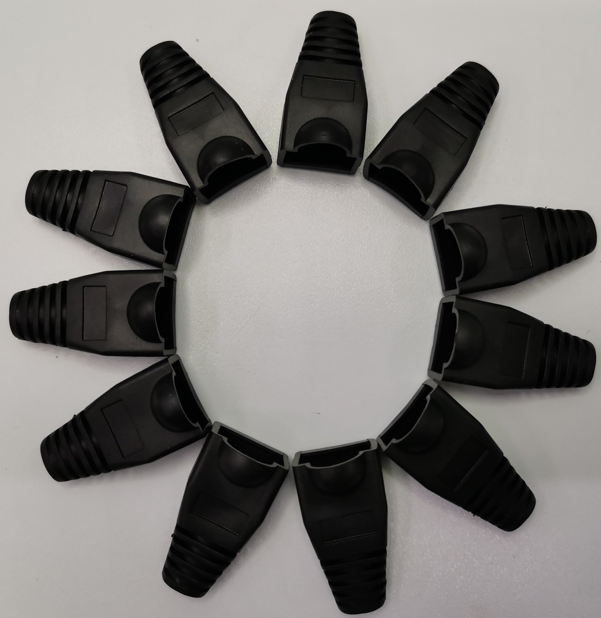 Black Rubber BooT RJ45 Grippes arranged in a circular pattern for cable protection and strain relief