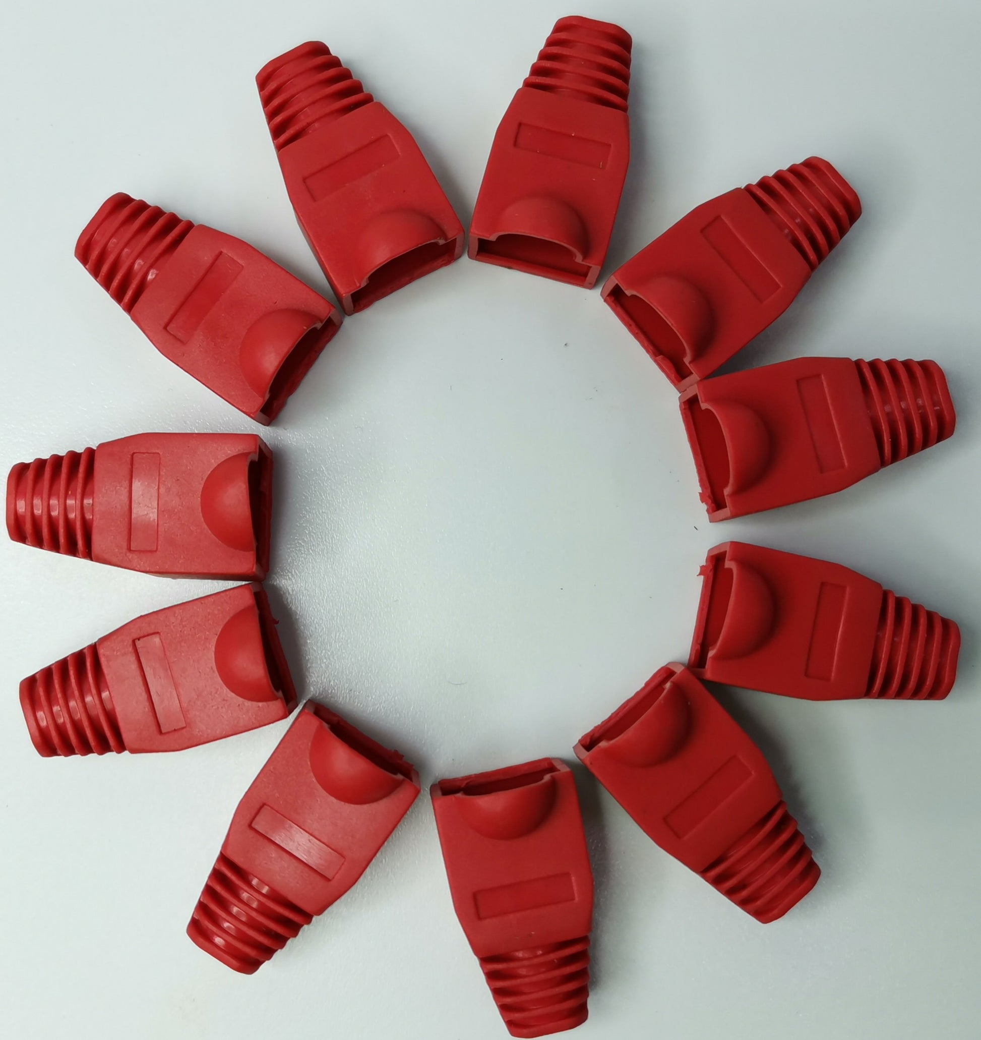 Red Rubber BooT RJ45 Grippes arranged in a circle for electrical circuitry protection