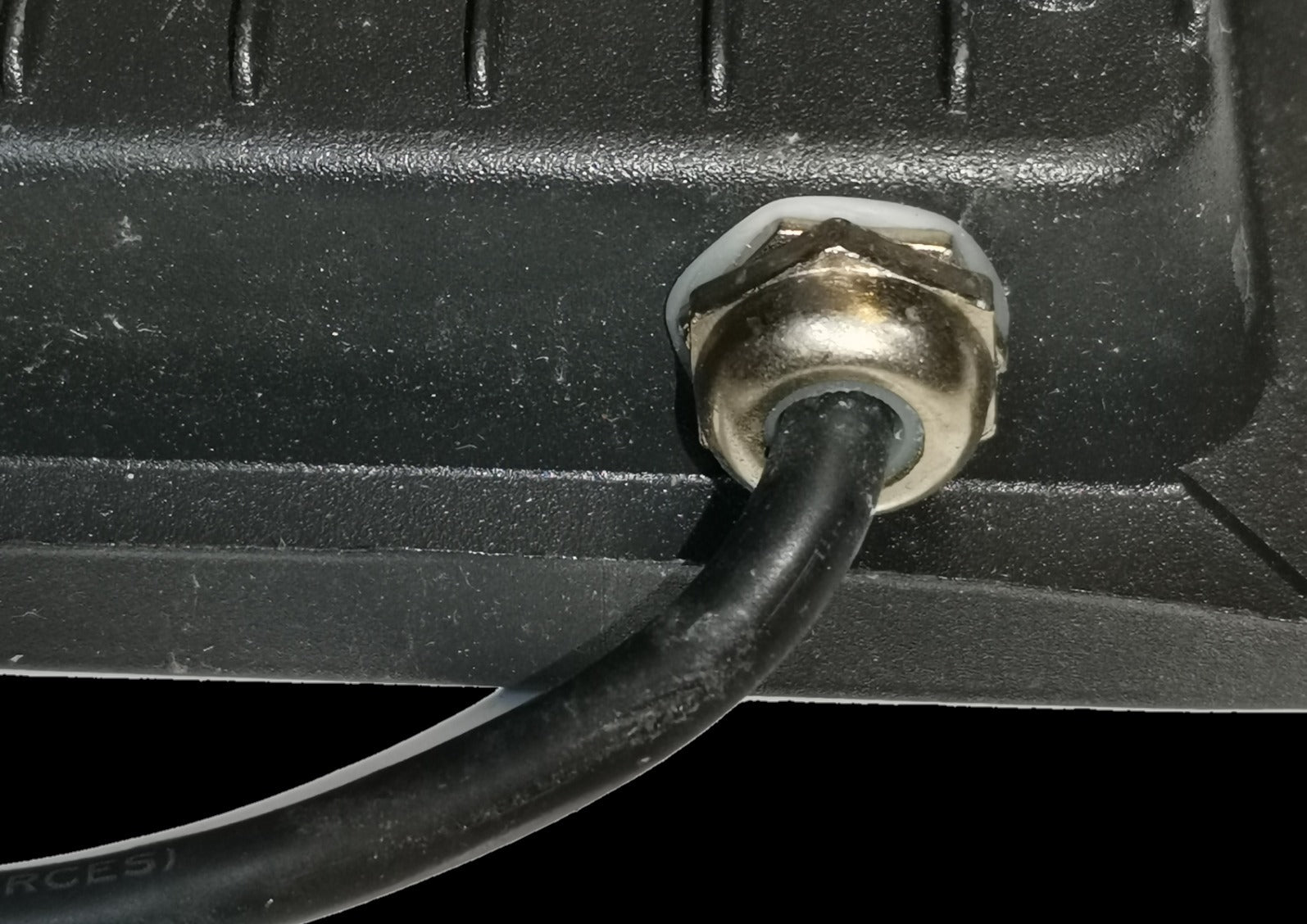 Close-up of Denko waterproof 10W LED light for outdoor use power cable connection with metal fastening