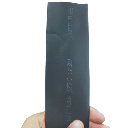 Hand holding 30mm Shrinkable Tube Black. Heat shrink sleeve for cable management with embossed markings