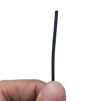 Close-up of Heat Shrinkable Tube Black - 1mm held between fingers for cable management